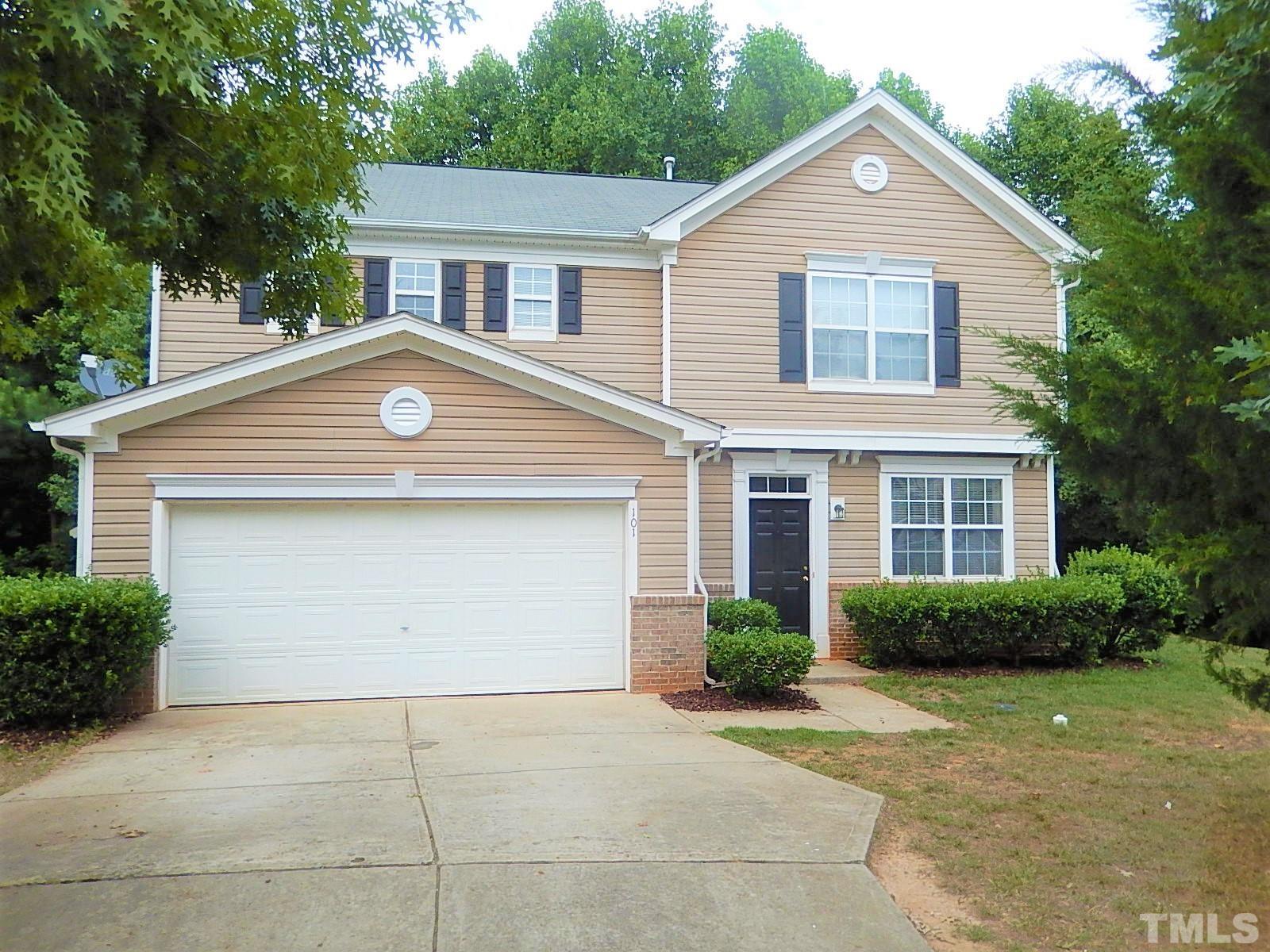 101 Olvera Way Holly Springs, NC 27540 - Photo 1 of 25 a front view of a house with a yard and garage
