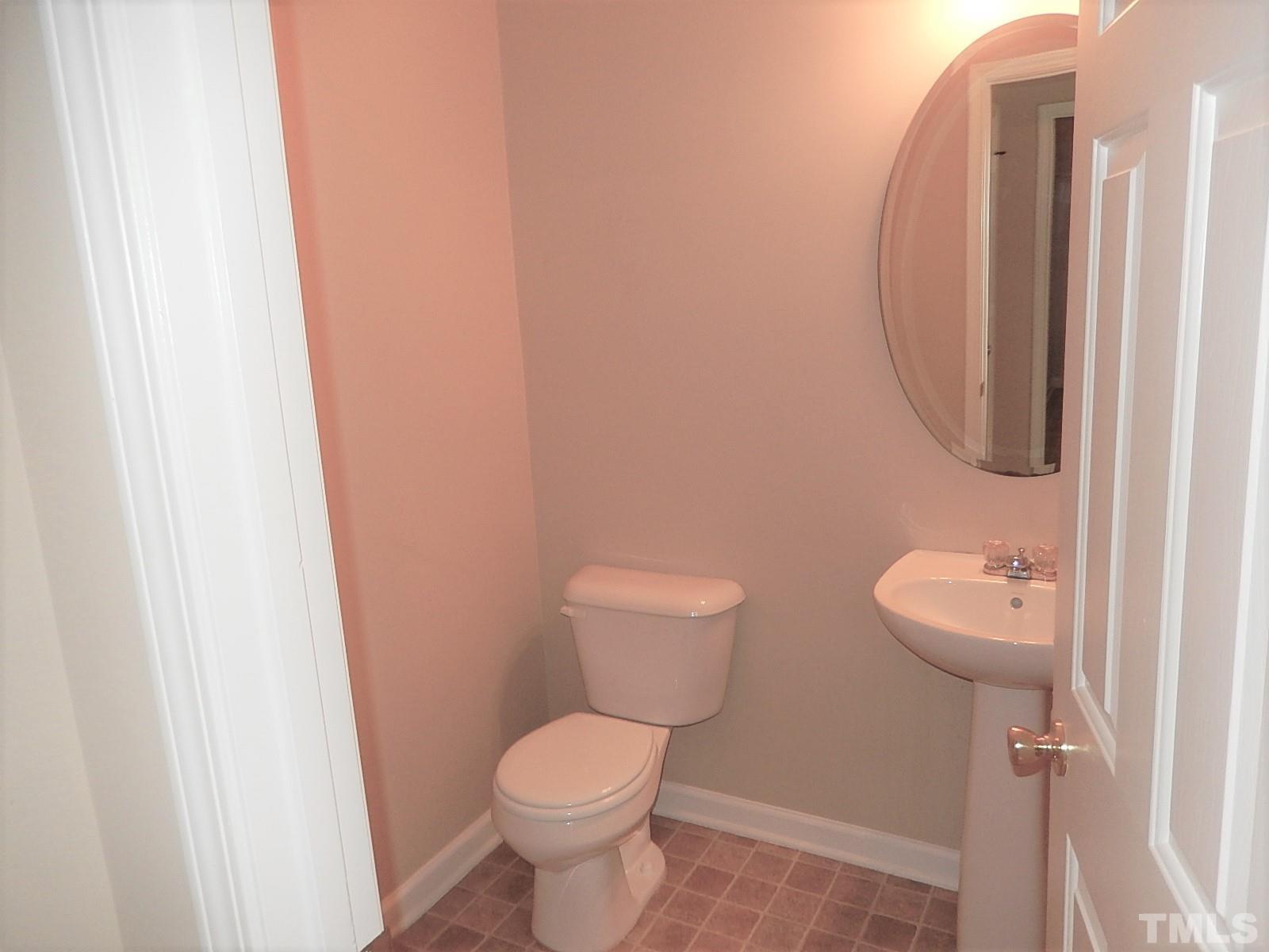 101 Olvera Way Holly Springs, NC 27540 - Photo 12 of 25 a bathroom with a toilet and a sink