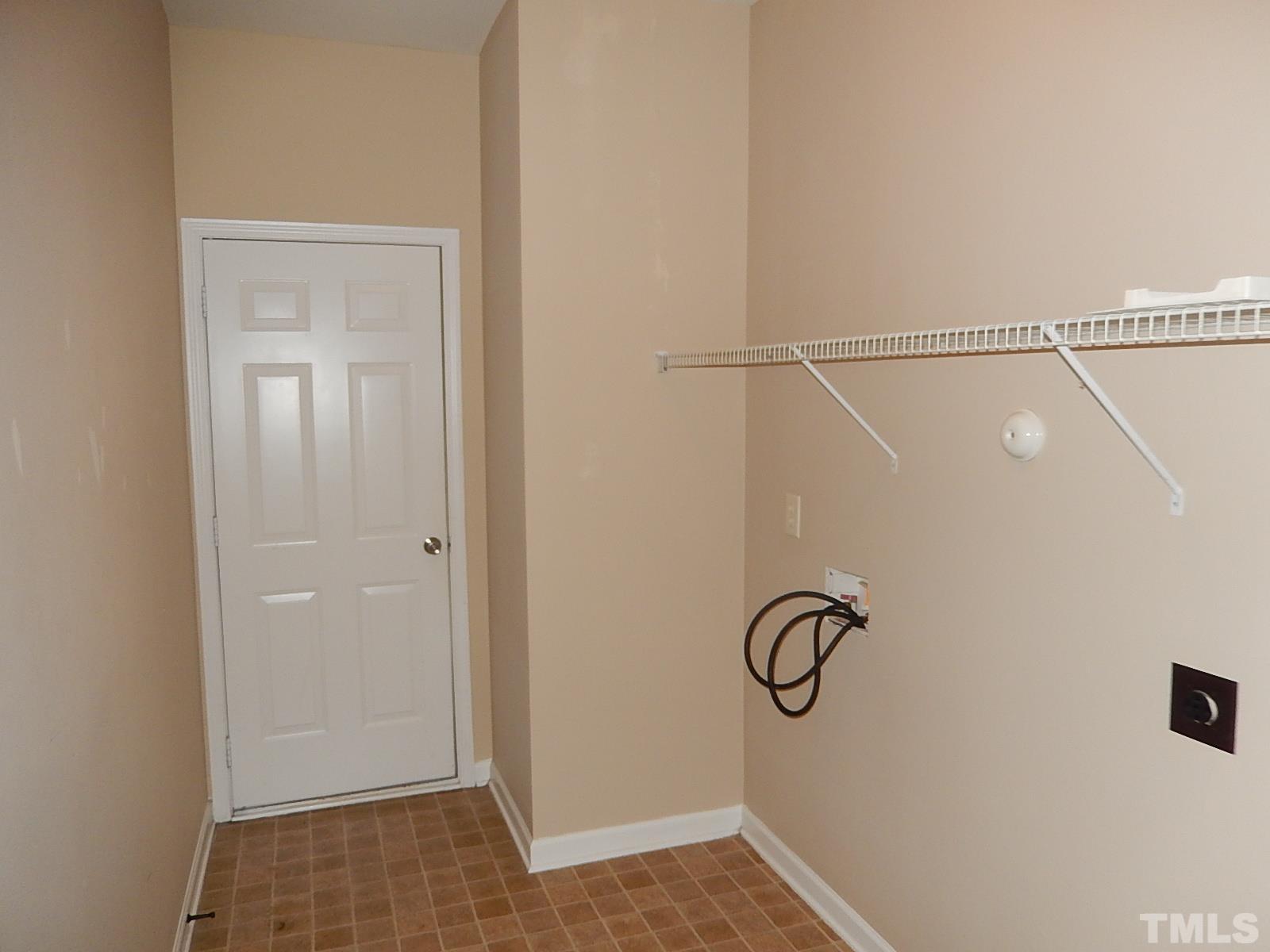 101 Olvera Way Holly Springs, NC 27540 - Photo 14 of 25 a view of a room with rack on the wall