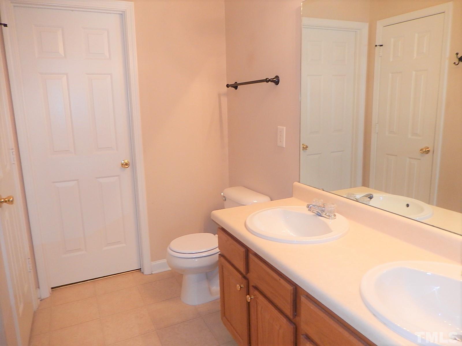 101 Olvera Way Holly Springs, NC 27540 - Photo 17 of 25 a bathroom with a sink toilet and vanity
