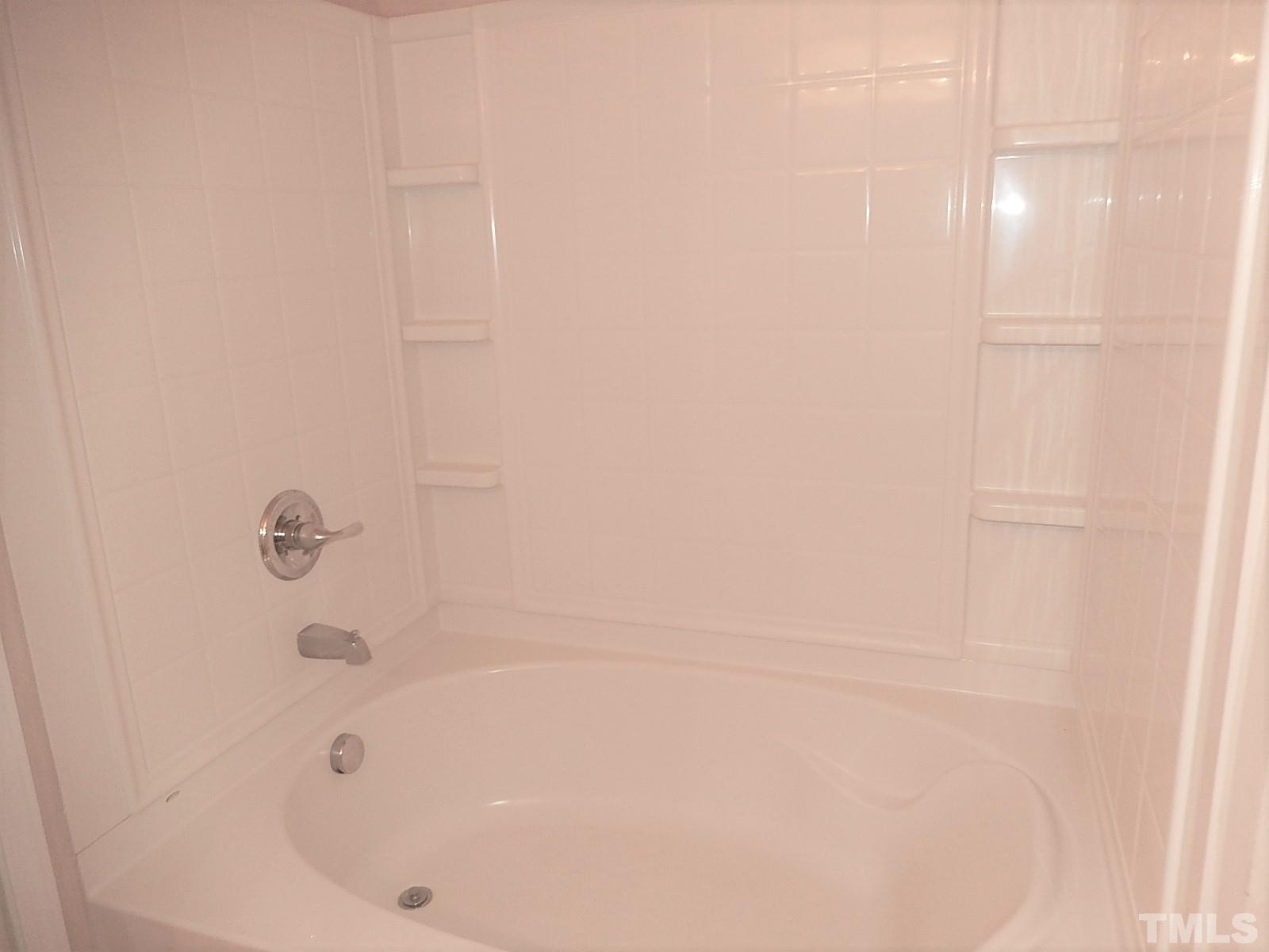 101 Olvera Way Holly Springs, NC 27540 - Photo 18 of 25 a bathroom with a bathtub