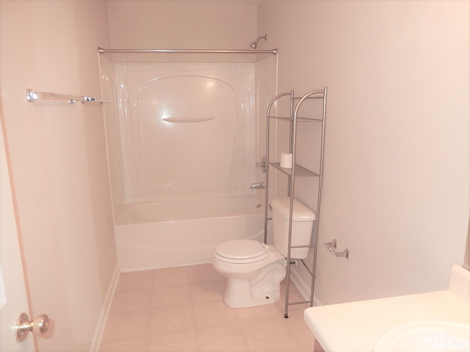 101 Olvera Way Holly Springs, NC 27540 - Photo 21 of 25 a bathroom with a toilet and a shower