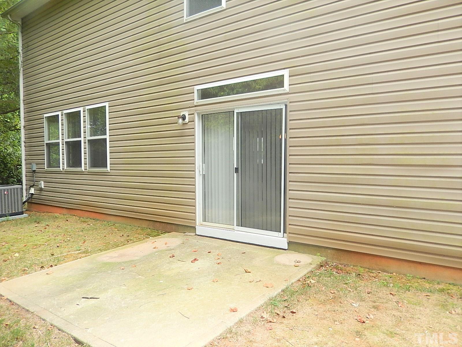 101 Olvera Way Holly Springs, NC 27540 - Photo 23 of 25 a view of a backyard with a large tree