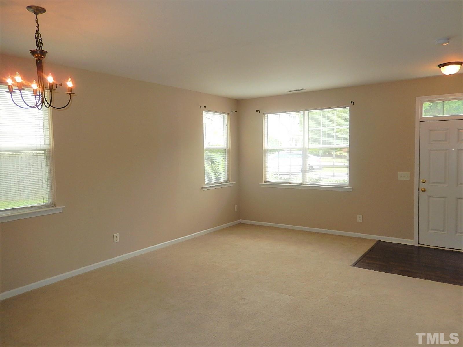 101 Olvera Way Holly Springs, NC 27540 - Photo 4 of 25 a view of an empty room with a window