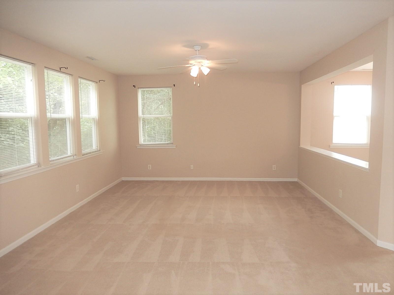 101 Olvera Way Holly Springs, NC 27540 - Photo 5 of 25 an empty room with a window