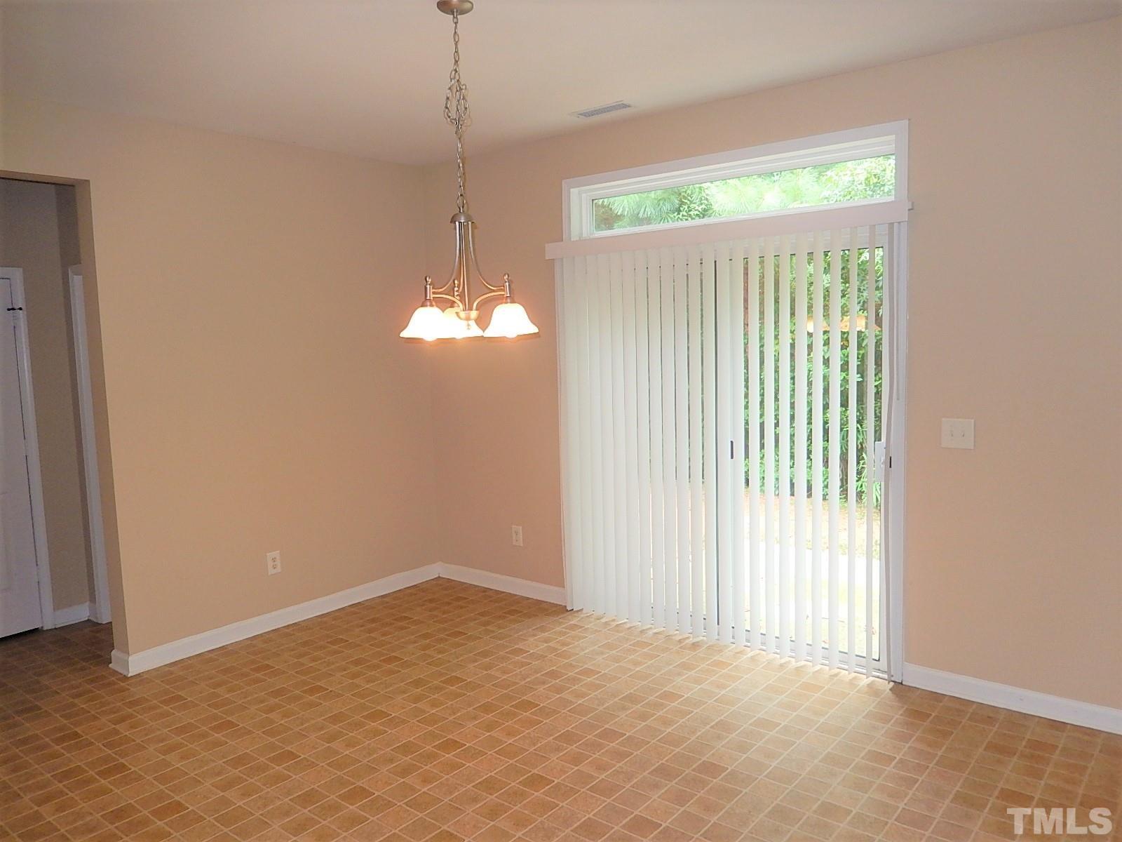 101 Olvera Way Holly Springs, NC 27540 - Photo 6 of 25 a view of an empty room with a window