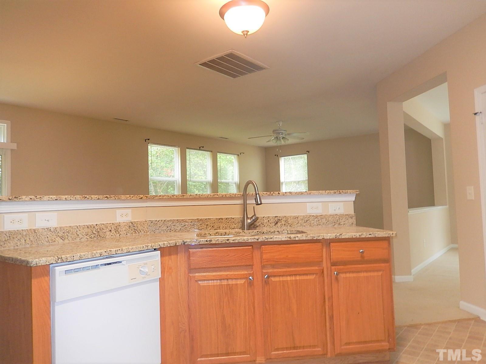 101 Olvera Way Holly Springs, NC 27540 - Photo 8 of 25 a bathroom with granite countertop a sink and a window