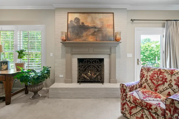 a living room with furniture flowerpot and a flat screen tv