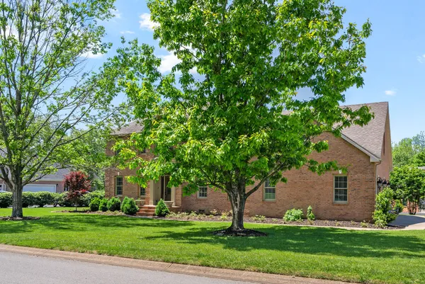 a front view of house with yard and green space