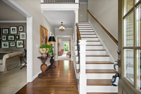 a view of an entryway with wooden floor and door