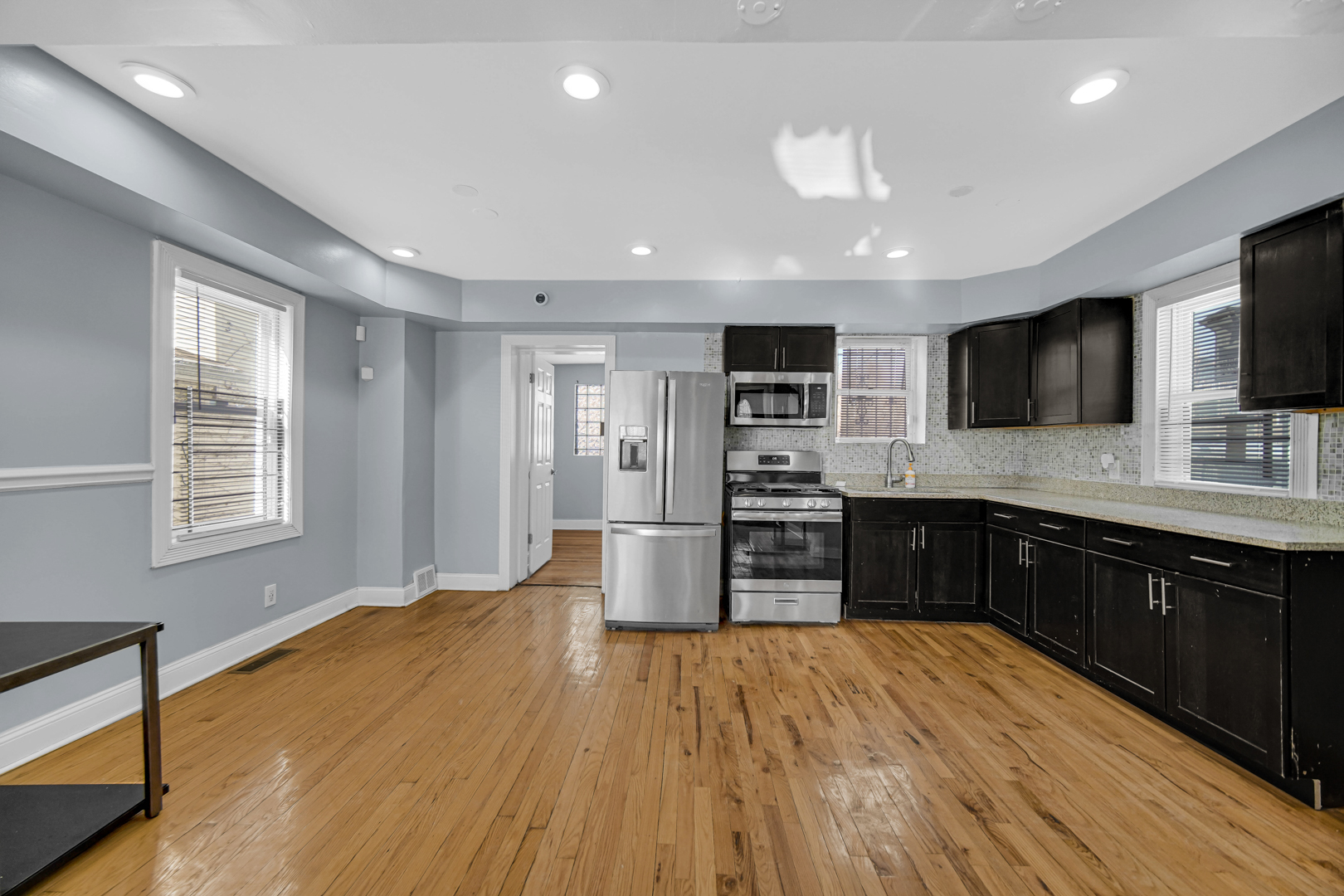 1336 East 73rd Street Chicago, IL 60619 - Photo 6 of 16 a kitchen with stainless steel appliances a refrigerator and a sink