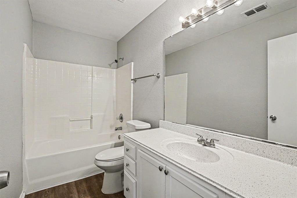 138 Kings Way Drive Rhome, TX 76078 - Photo 11 of 16 a bathroom with a granite countertop sink toilet and shower