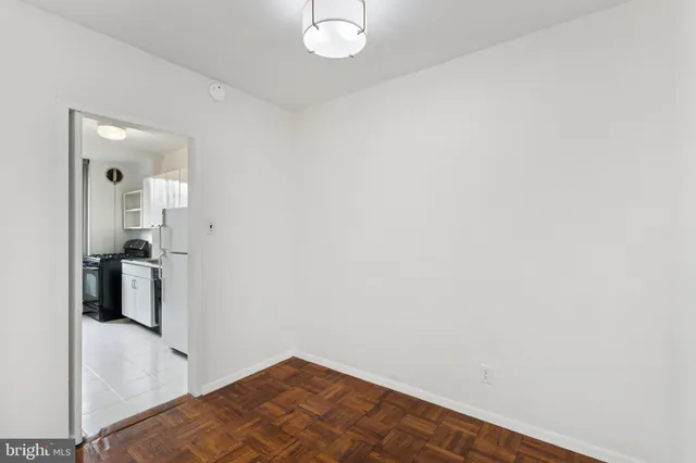 a view of a room with wooden floor and a hallway