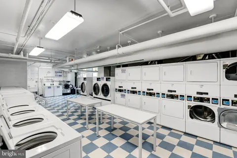 a kitchen with a stove sink and white cabinets