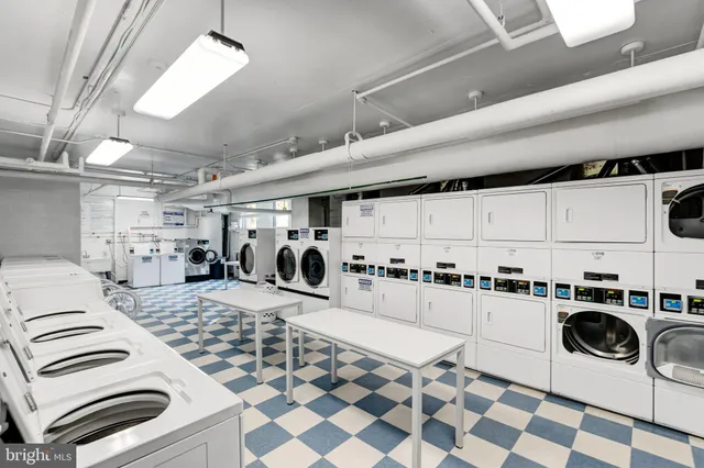 a kitchen with a stove sink and white cabinets