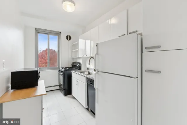 a white refrigerator freezer sitting in a kitchen