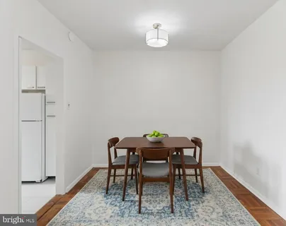 a view of a workspace room with wooden floor and table