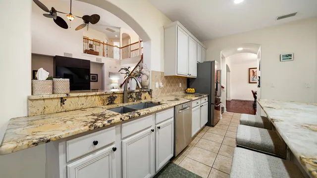 a bathroom with a granite countertop tub sink and mirror