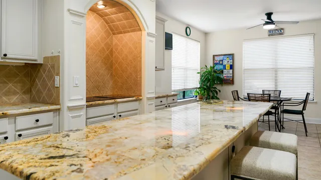 a view of a workspace with furniture and a window