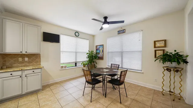a bathroom with a granite countertop sink mirror vanity and toilet