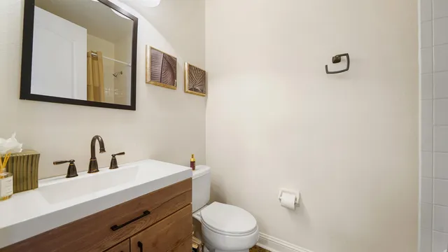 a view of a hallway with wooden floor and stairs