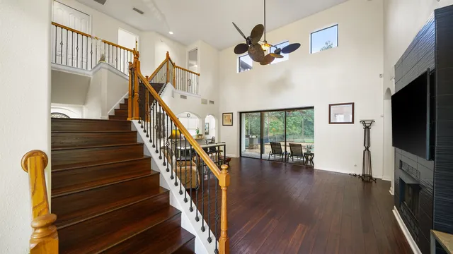 a living room with furniture flat screen tv and a large window
