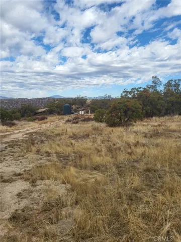 a view of a wall with sink and wooden fence