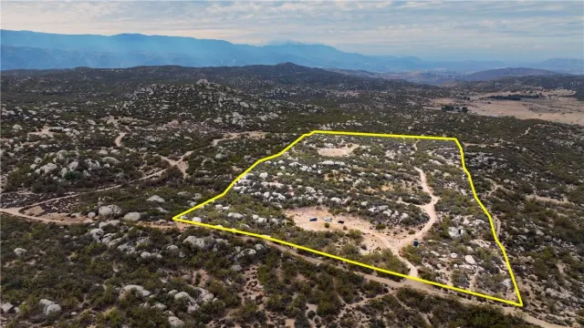 a view of a mountain in the distance in a field