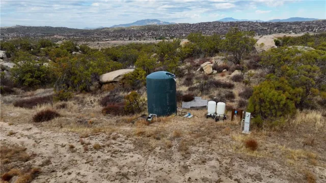 an aerial view of residential house with residential space and trees
