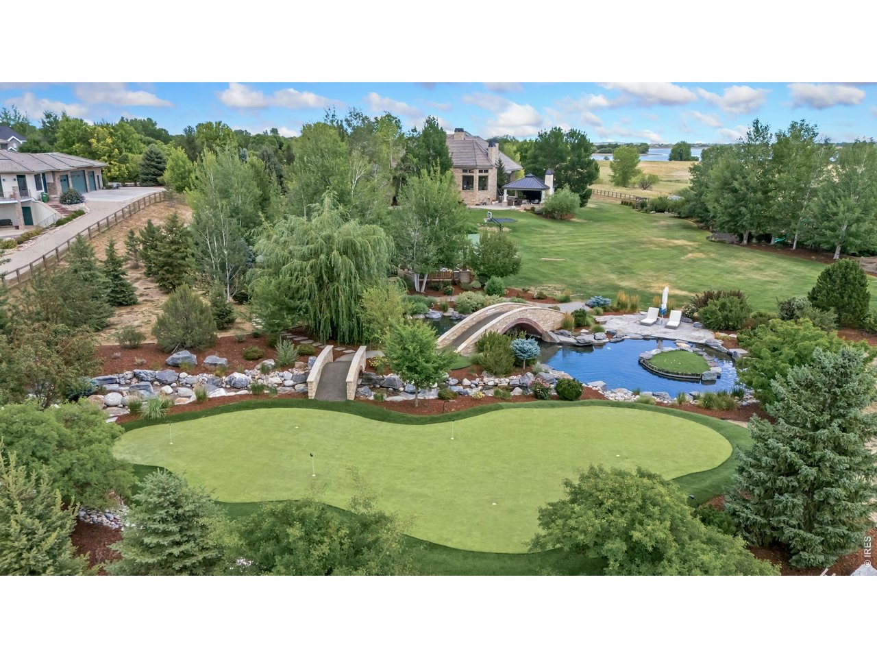 6558 Rookery Road Fort Collins, CO 80528 - Photo 42 of 50 Two Custom Bridges, Pool, Rock Stream Down to Pool, Putting/Chipping Green
