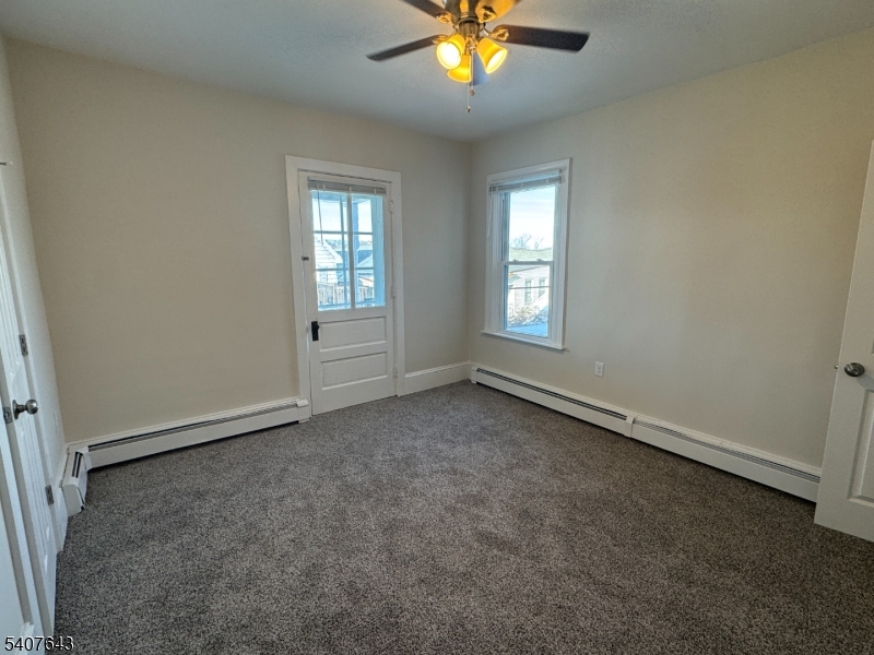 27 Filmore Street Phillipsburg, NJ 08865 - Photo 12 of 15 an empty room with windows and chandelier fan