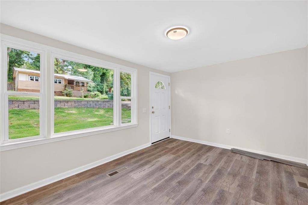 136 Nowell Street Monroe, GA 30655 - Photo 10 of 25 a view of empty room with wooden floor and fan