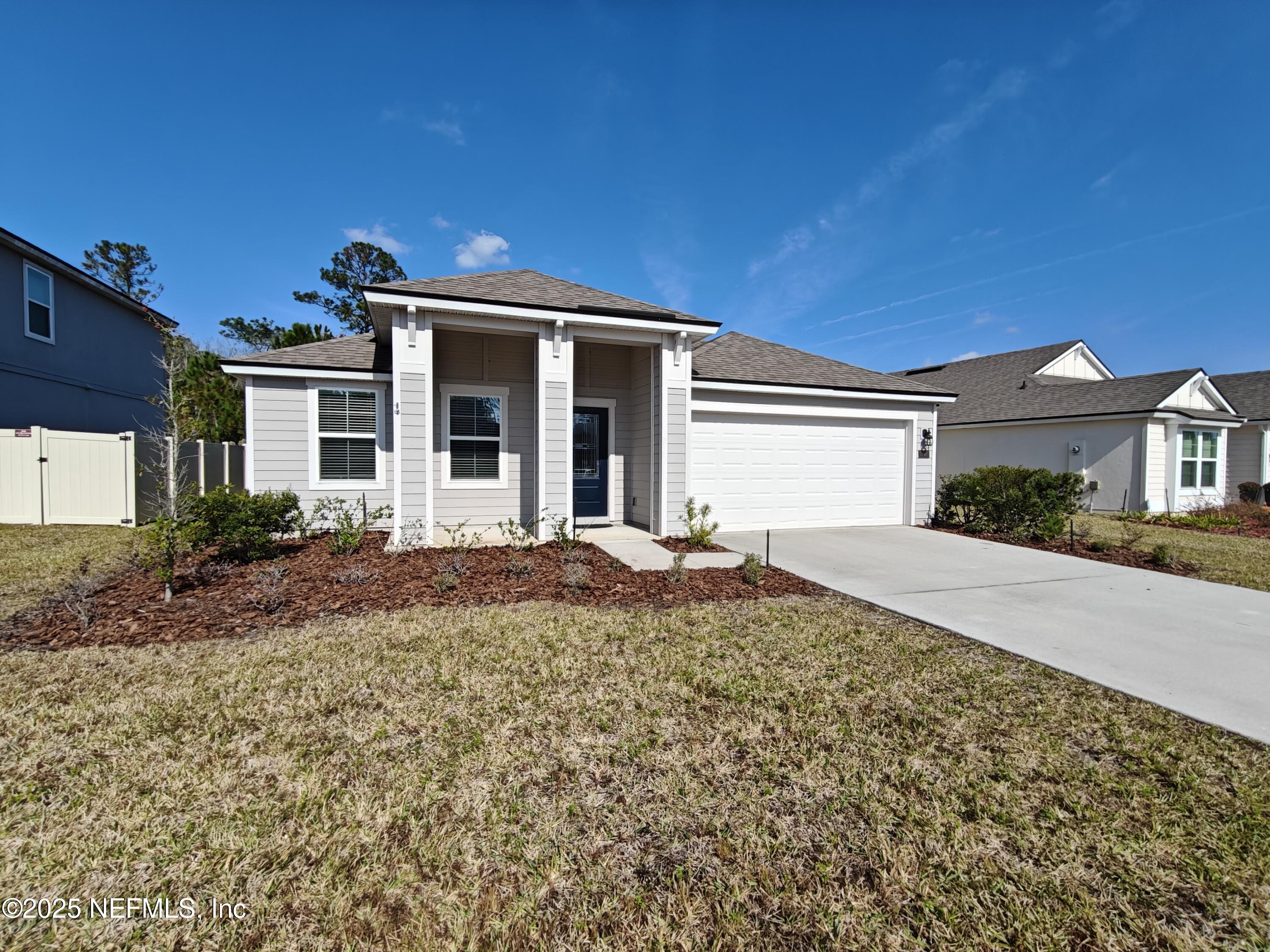 70481 Winding River Drive Yulee, FL 32097 - Photo 1 of 53 front view of a house with a small yard
