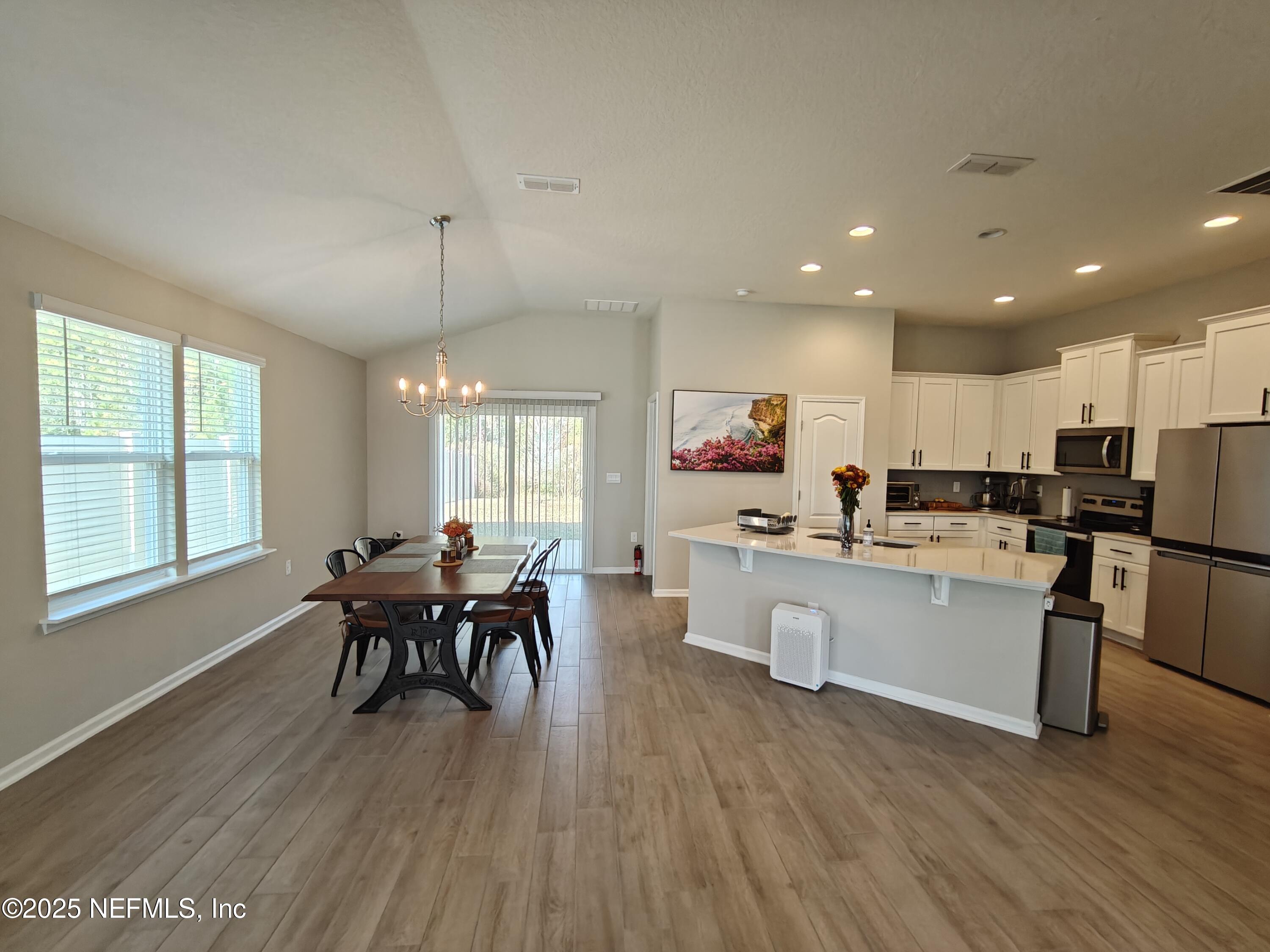 70481 Winding River Drive Yulee, FL 32097 - Photo 12 of 53 a living room with stainless steel appliances granite countertop furniture wooden floor and a kitchen view