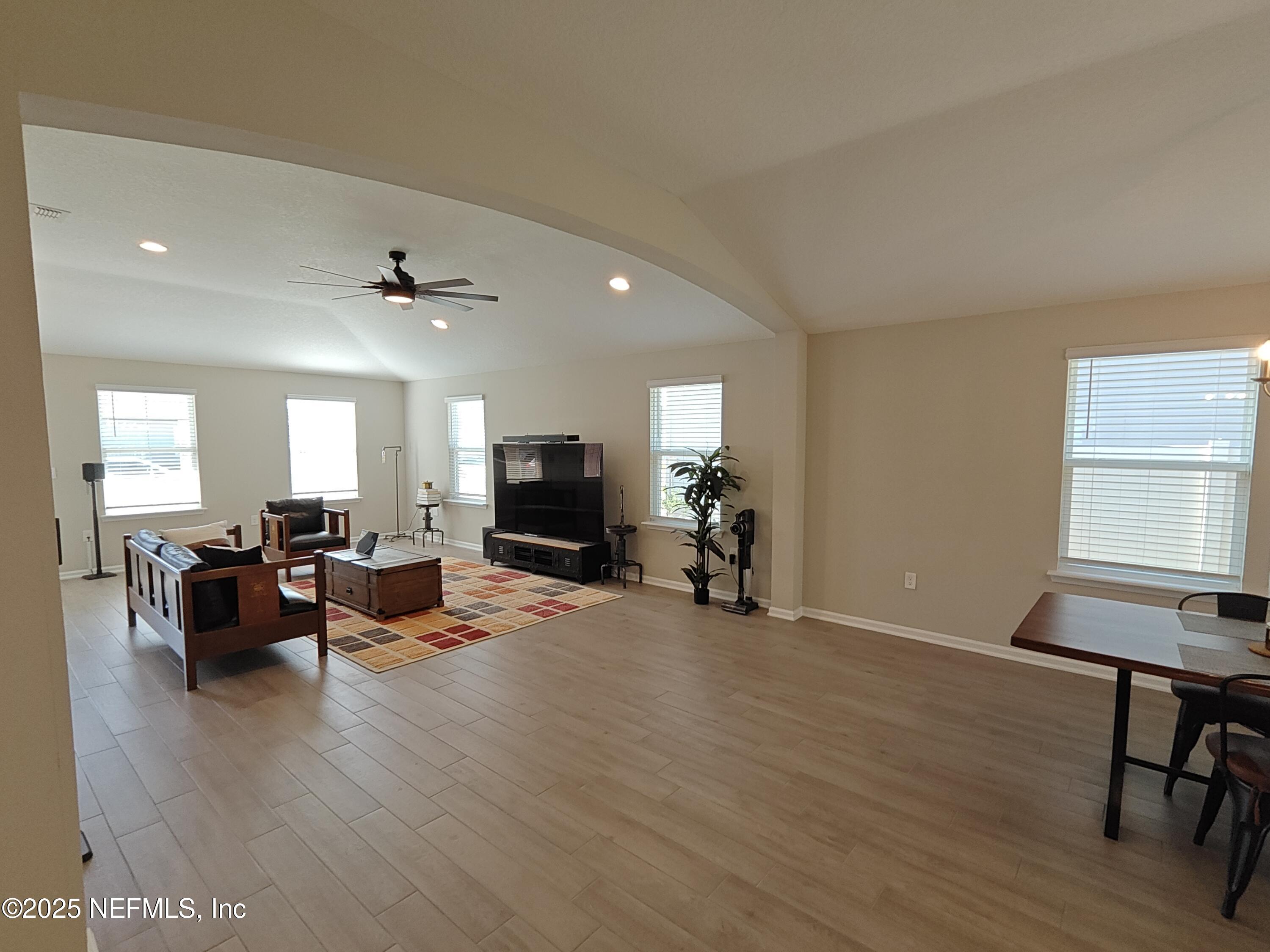 70481 Winding River Drive Yulee, FL 32097 - Photo 16 of 53 a view of a livingroom with furniture and a flat screen tv