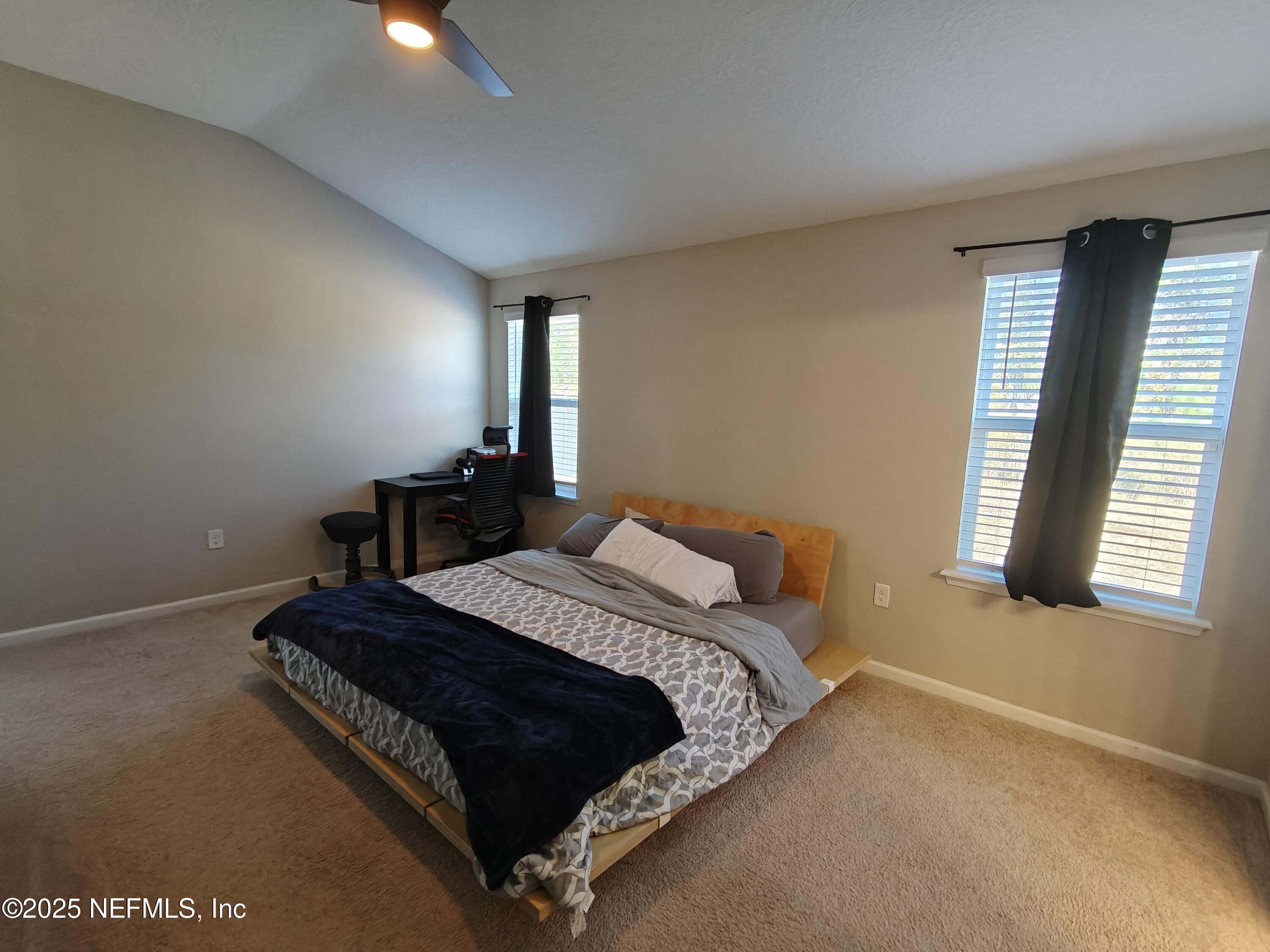 70481 Winding River Drive Yulee, FL 32097 - Photo 25 of 53 a bed sitting in a bedroom next to a window