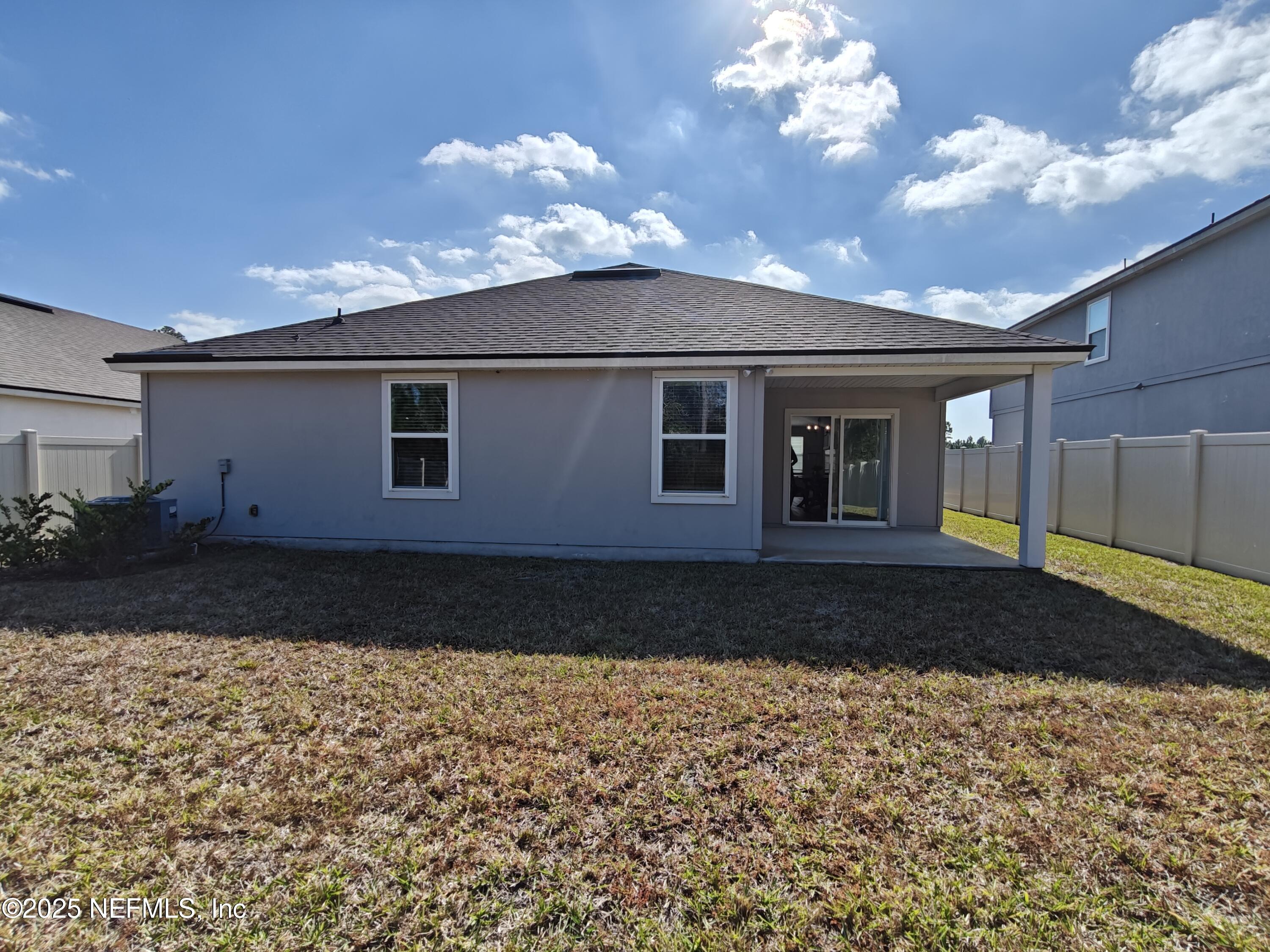 70481 Winding River Drive Yulee, FL 32097 - Photo 33 of 53 a front view of a house with a yard
