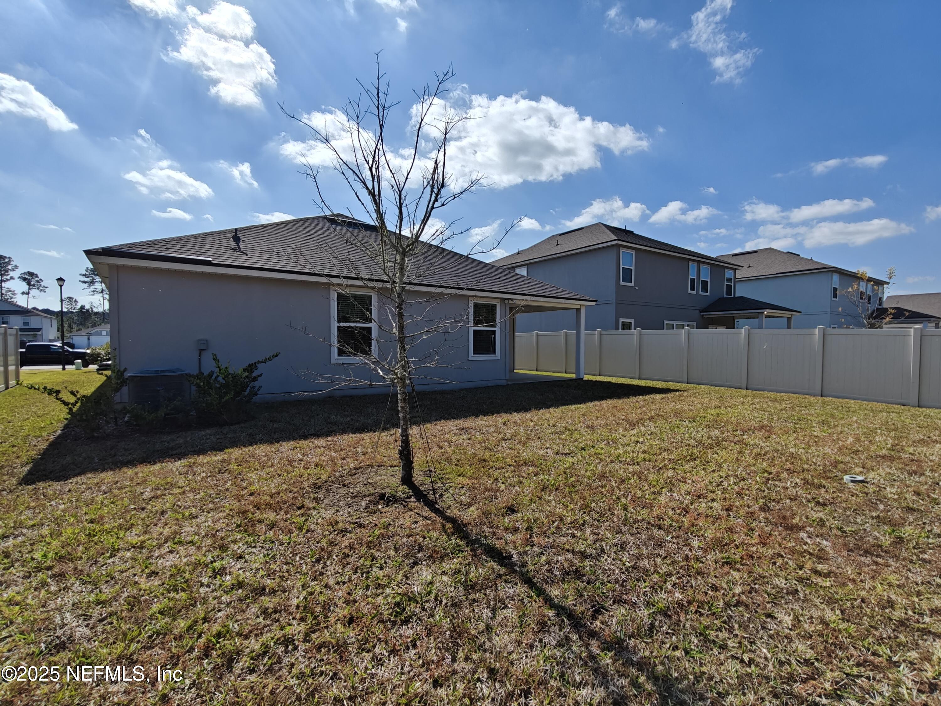 70481 Winding River Drive Yulee, FL 32097 - Photo 35 of 53 a house view with a backyard space
