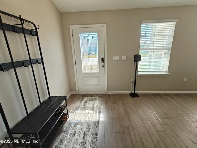 a bed sitting in a bedroom next to a window