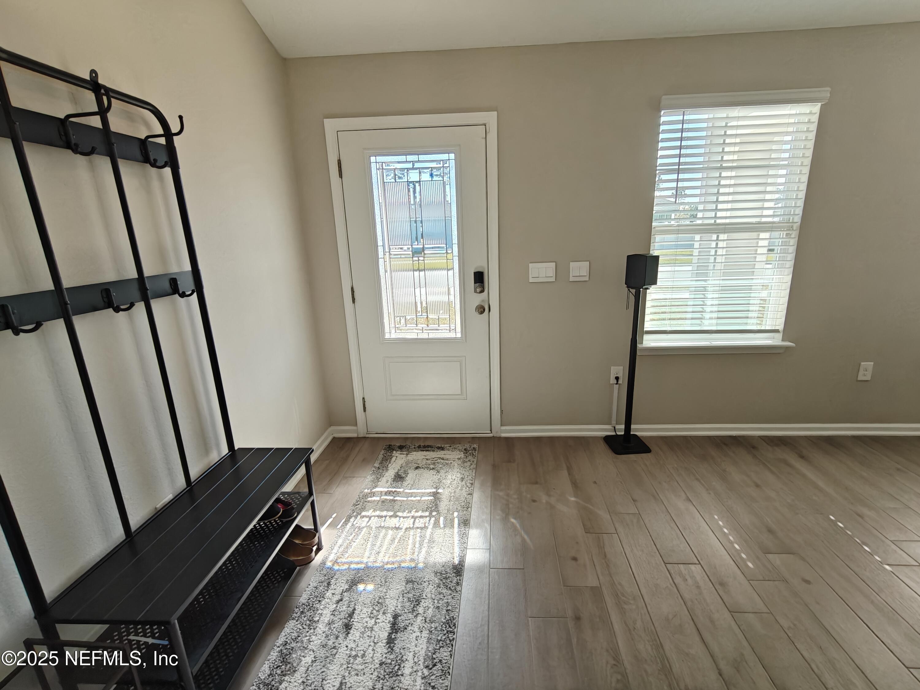 70481 Winding River Drive Yulee, FL 32097 - Photo 7 of 53 a view of an empty room with wooden floor and a window