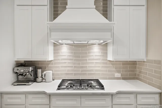 a kitchen with a stove and cabinets
