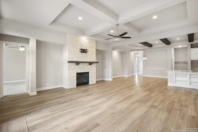 wooden floor in an empty room with a fireplace