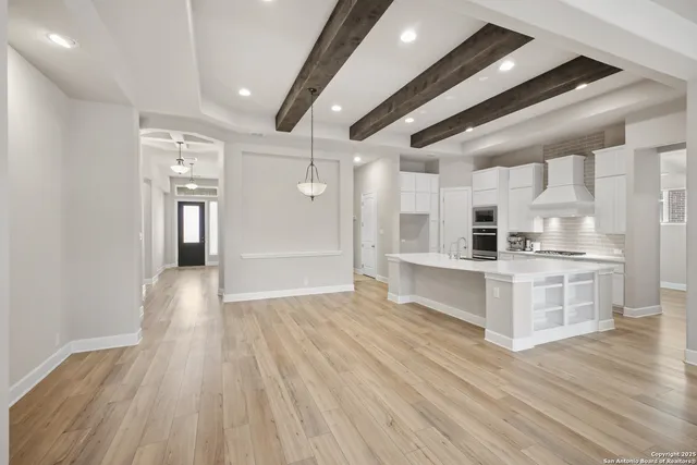 a view of kitchen with wooden floor and electronic appliances