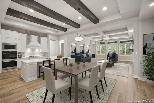 a dining area with stainless steel appliances kitchen island granite countertop a dining table chairs and view living room