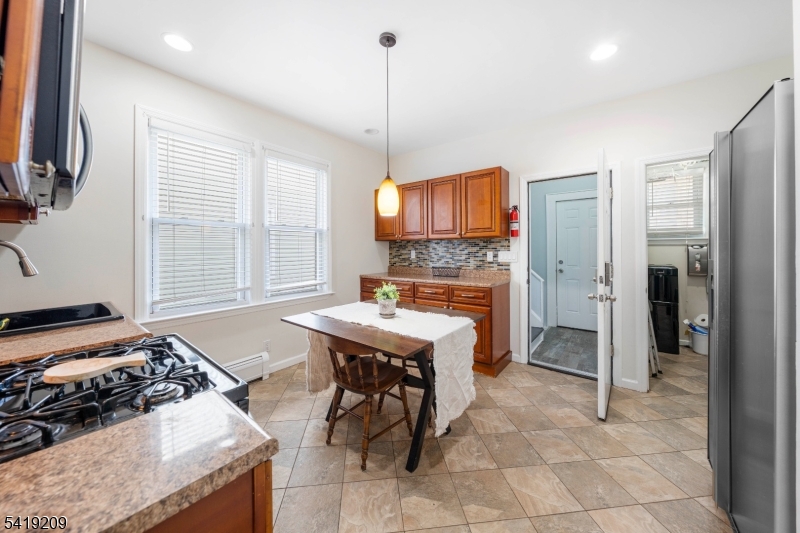 752 Eaton Street Elizabeth, NJ 07202 - Photo 11 of 27 a kitchen with stainless steel appliances granite countertop a stove oven and a refrigerator