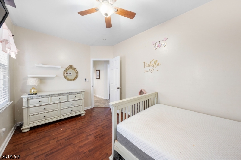 752 Eaton Street Elizabeth, NJ 07202 - Photo 17 of 27 a bedroom with a bed and a dresser