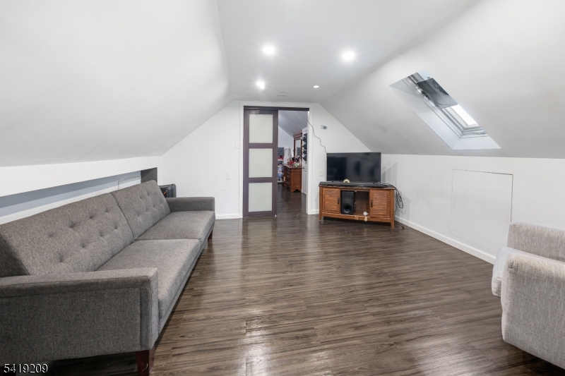 752 Eaton Street Elizabeth, NJ 07202 - Photo 19 of 27 a living room with furniture and a wooden floor