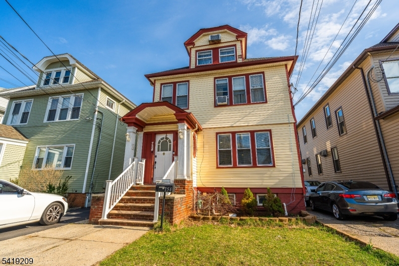 752 Eaton Street Elizabeth, NJ 07202 - Photo 2 of 27 a front view of a house with a yard