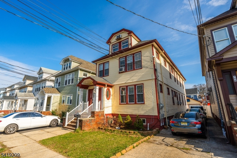 752 Eaton Street Elizabeth, NJ 07202 - Photo 3 of 27 a front view of a house with a yard