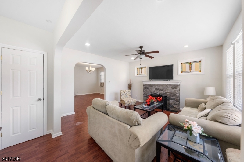 752 Eaton Street Elizabeth, NJ 07202 - Photo 8 of 27 a living room with furniture a fireplace and a flat screen tv